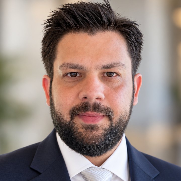 Panagiotis Kintis, head and shoulders, in a navy suit